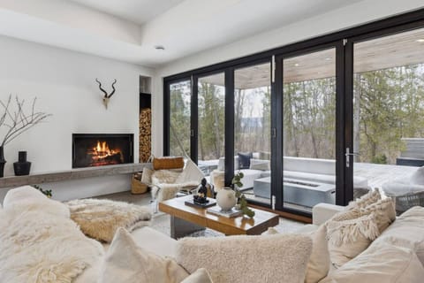 Unwind by your cozy fireplace and soak in serene forest views through the floor-to-ceiling windows.