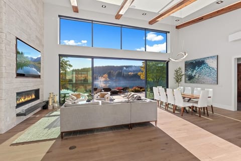Sunlit living room with panoramic mountain views and cozy fireplace