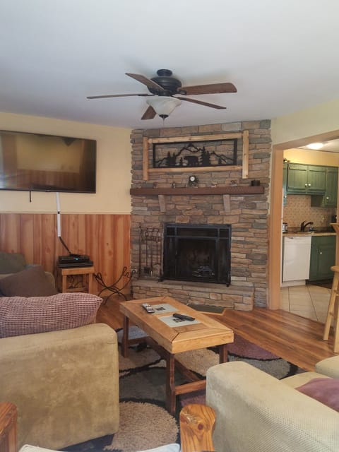 Living Room with wood burning Fireplace.  and 60-inch TV