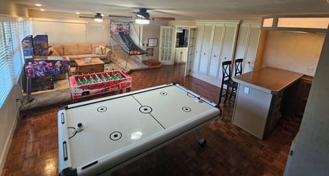 Game room with air hockey, foosball, pinball, darts, basketball and more