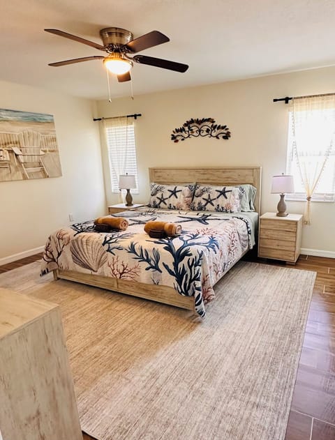 Wake up to coastal charm in this bright and spacious master bedroom.