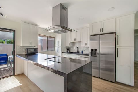 Modern kitchen with sleek countertops and stainless steel appliances.