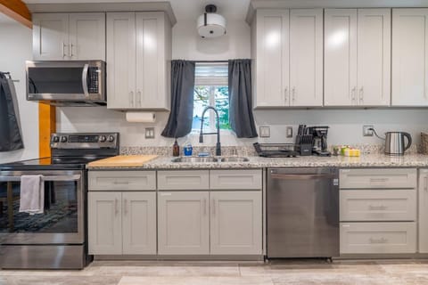 Prepare meals with ease in this fully-equipped kitchen boasting stainless steel appliances and ample cabinet space.