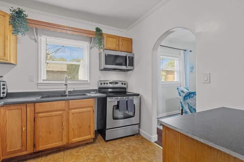 Another view of the kitchen showing the spacious countertops and large windows.