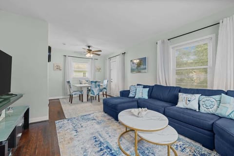 Open-concept space connecting the living and dining areas, filled with natural light and comfortable seating.