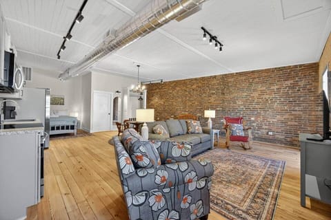 Relax in this cozy living room and watch your favorite show. Enjoy the view as you rock by the window. The 4K Smart TV has all your favorite streaming services pre-downloaded. Bring your own login.