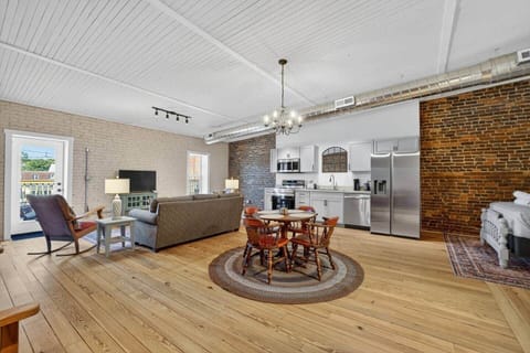 Dine with family and friends around this antique table and chairs on a braided rug under a dimmable chandelier.