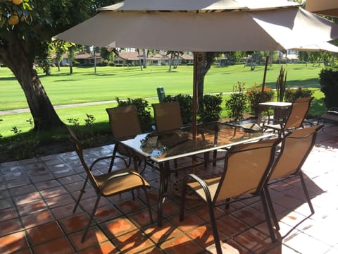 Beautiful outdoor patio with gas grill overlooking pristine fairway.