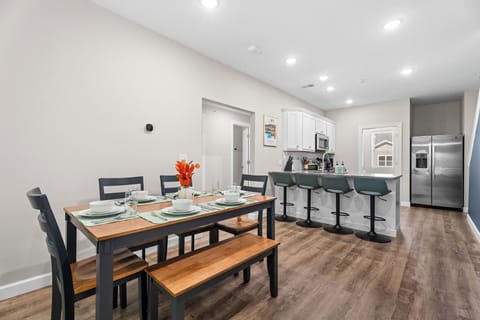 The dining table seats 6 comfortably with 4 more adjustable bar stools close by.