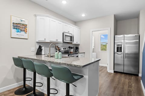 Bar seating area between the kitchen and the dining table.