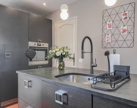 Fully equipped kitchen with oven, fridge, freezer, dishwasher, stove.