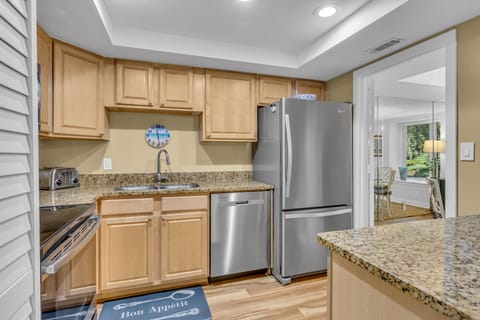 Your fully equipped kitchen features granite counters, stainless appliances, and warm wood cabinets for preparing memorable meals.