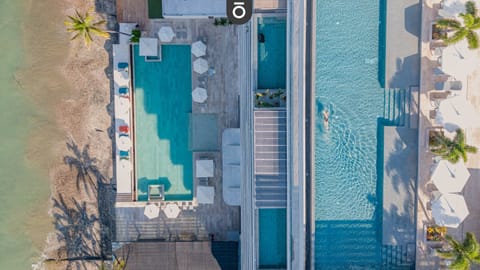 Drone view of our beachfront property - heated rooftop and beachside salt water pools with endless views await you!