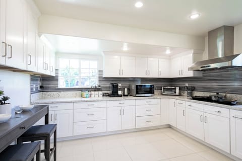 Bright modern kitchen with stainless steel appliances and granite counters.