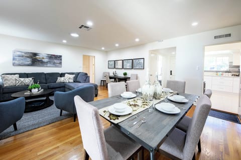 Spacious open-plan living room with comfy sectional and enough dining seating.