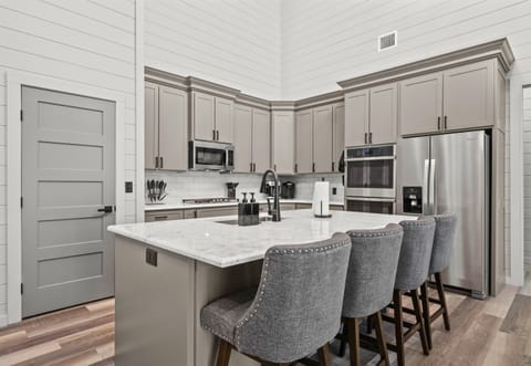 With modern appliances and bar seating for guests, this kitchen makes mealtime feel like part of the fun.