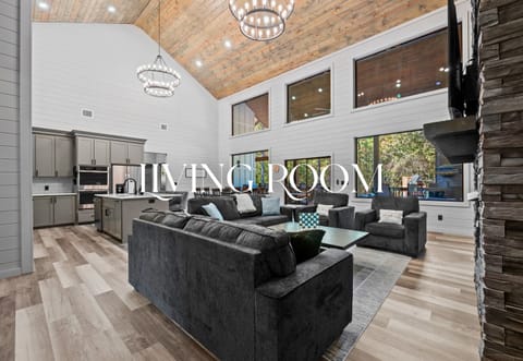 Step inside to a bright, airy living room that instantly makes you feel at home with vaulted ceilings and soft, inviting furniture.