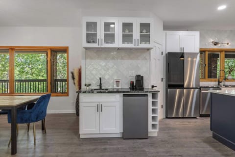 The kitchen features a wet bar with a wine fridge and Keurig coffee maker.