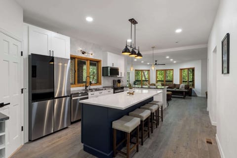The kitchen features brand new stainless steel appliances.
