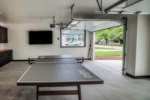 Play a lively game of ping pong beside a large window framing stunning views of Lambeau Field. This bright, energetic space combines fun and iconic scenery—perfect for memorable gatherings and Packers game day excitement.