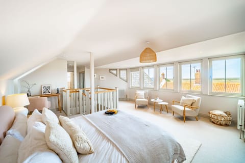 White Horses, Blakeney: Master bedroom with marsh views over the rooftops
