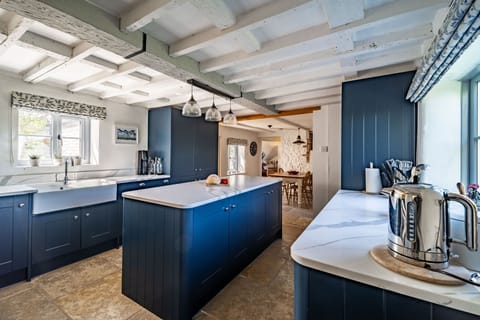 Ground floor: Kitchen / breakfast room with a Range oven with five gas burner, Butler's sink, fridge/ freezer and dishwasher