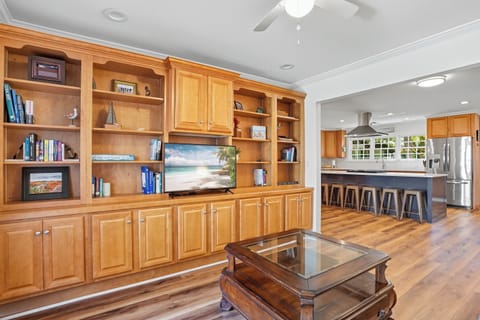 Den with Built-In Shelving - Inviting den with custom built-ins, smart TV, and open flow into the kitchen—perfect for a quiet read, movie night, or catching the game while dinner’s cooking.