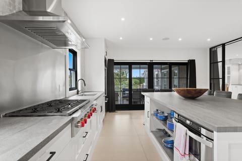 View from kitchen to covered outdoor dining area. Easy access to open dining.