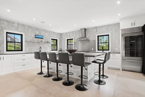 Modern eat-in kitchen fully equipped and ready to prepare and serve many. 