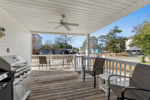 Spacious covered deck with grill and waterfront views