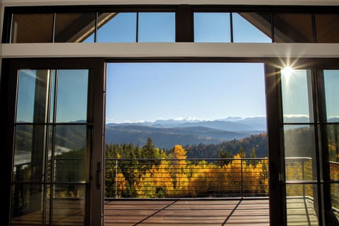 The massive sliding glass doors of the Primary Suite open to a private deck