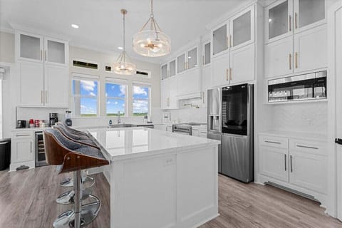 Luxury chef's kitchen with quartz countertops, custom cabinetry, and stainless appliances in a Galveston beach vacation home.