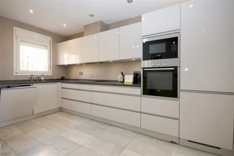 Modern and spacious kitchen is fully equipped with all the appliances