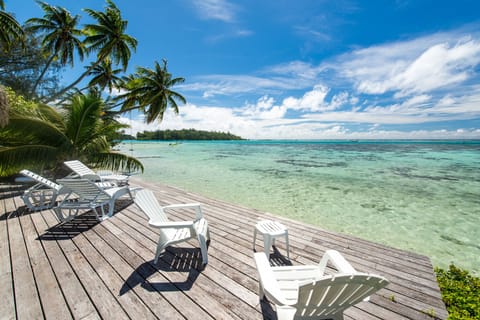 Lagoon-front deck in Moorea with lounge chairs for relaxing under the tropical sun