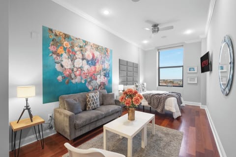 Spacious Northern Liberties studio with queen bed, full kitchen, modern bathroom, and arched windows throughout.