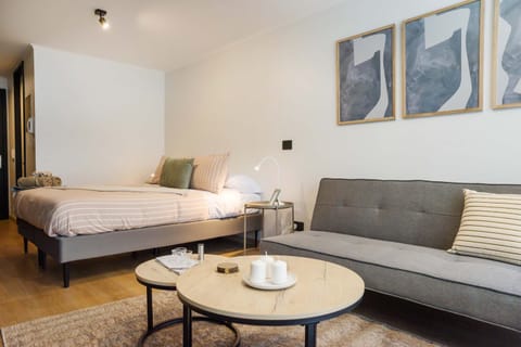 Modern studio with cozy bed and stylish decor, perfect for a relaxing stay in Chile's vibrant heart.