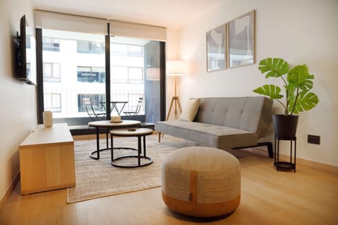 Relax in this stylish living area with a balcony view, perfect for unwinding in the city center.