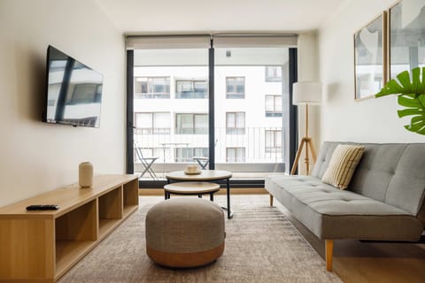 Bright and modern living area with balcony access, perfect for relaxation and enjoying city views.