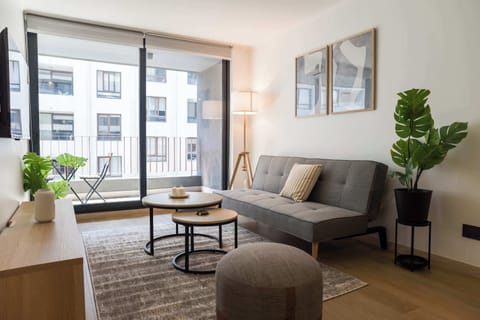Modern living area with balcony access, perfect for relaxation and city views.