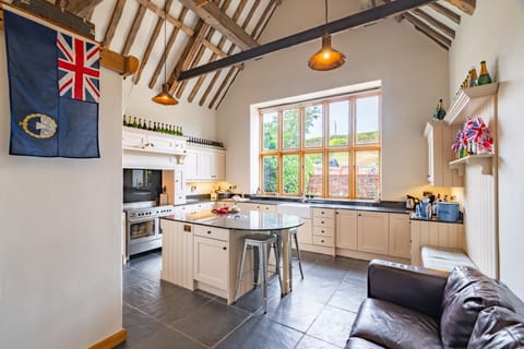 Ground floor: Kitchen with a Range oven with electric hob, coffee machine, dishwasher, fridge/freezer, microwave, washer/dryer, toaster, breakfast bar island and sofa