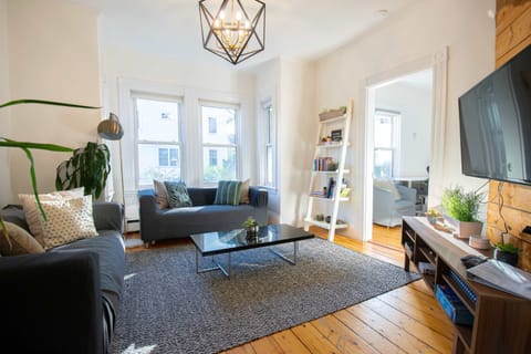 Sun soaked living room features 2 couches and a Smart TV
