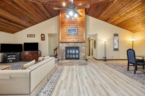 Soaring ceilings and the cozy fireplace are in the living room
