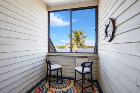 Cozy sunroom retreat with ocean views and charming decor
