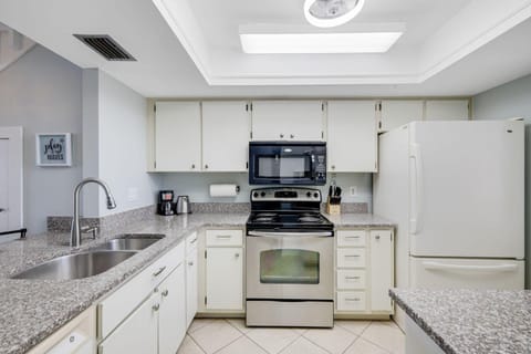 Bright, modern kitchen with granite countertops and stainless appliances