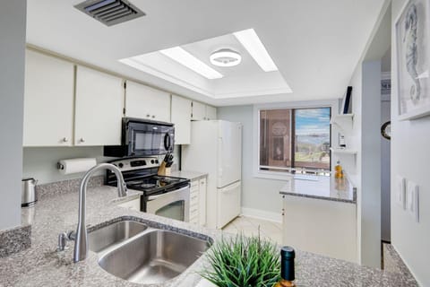 Bright, modern kitchen with scenic window views and sleek finishes