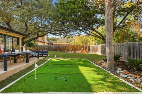 Putt-putt area with large outdoor dining table for group meals