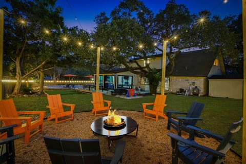 Gas fire pit with seating for 8 and overhead string lights