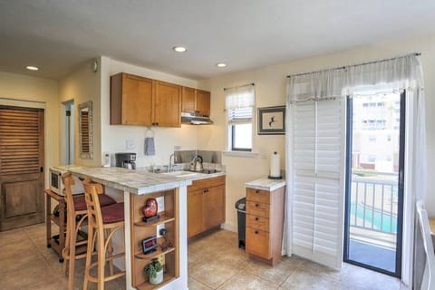 Kitchenette with full size fridge, a pool view, and bar stool or cafe seating