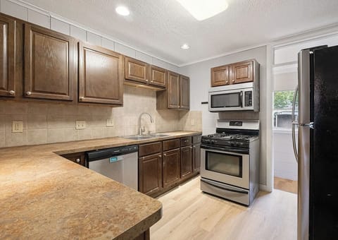 Kitchen, gas stove, microwave, and fridge