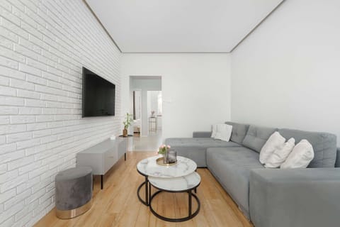Relax in the stylish living room with a comfortable sofa and modern decor.